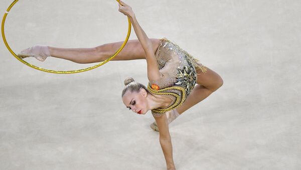 Yana Kudryavtseva (Russia) performs the hoop routine during the rhythmic gymnastics individual all-around competition at the XXXI Summer Olympics - Sputnik International