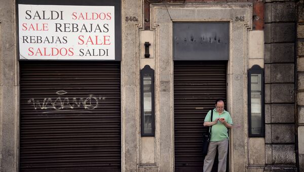 A man stands outside a closed shop indicating sales, in the shopping street of Via del Corso, in central Rome on July 3, 2016 - Sputnik International