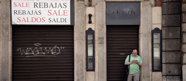 A man stands outside a closed shop indicating sales, in the shopping street of Via del Corso, in central Rome on July 3, 2016 - Sputnik International
