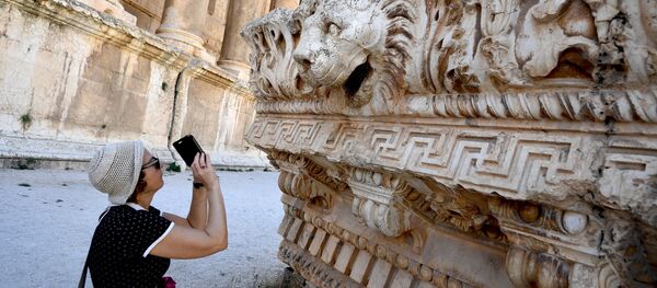 A visitor takes pictures of a bas-relief with heads of lions from the roof of the Temple of Jupiter in a temple complex of Baalbek, Lebanon A visitor takes pictures of a bas-relief with heads of lions from the roof of the Temple of Jupiter in a temple complex of Baalbek, Lebanon - Sputnik International