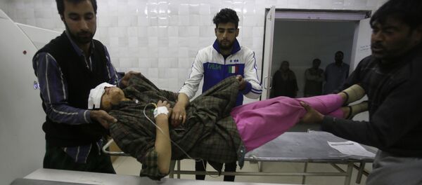 An injured Kashmiri woman is brought for treatment to a hospital in Srinagar, Indian controlled Kashmir, Monday, Oct. 31, 2016 - Sputnik International