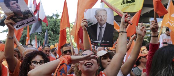 Supporters of Christian leader Michel Aoun hold his picture and Free Patriotic Movement, Lebanese flags and Hezbollah flag celebrate the election of the new President Michel Aoun, in Beirut, Lebanon, Monday, Oct. 31, 2016 - Sputnik International