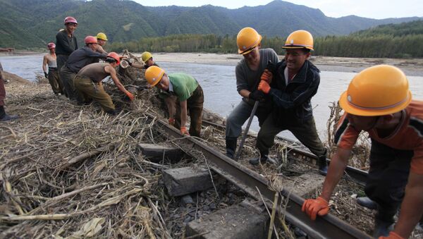 In this Friday, Sept, 16, 2016, file photo, workers repair the flood-damaged train track between Sinjon and Kanphyong train stations in North Hamgyong Province, North Korea - Sputnik International