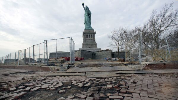 The Statue of Liberty stands beyond parts of a brick walkway damaged in Superstorm Sandy on Liberty Island in New York (File) - Sputnik International