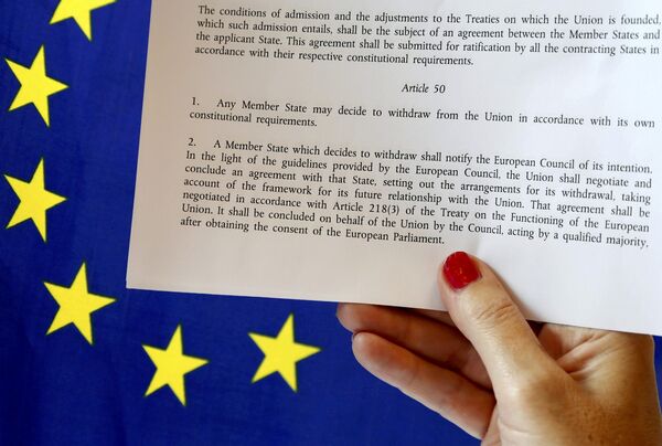 Article 50 of the EU's Lisbon Treaty that deals with the mechanism for departure is pictured near an EU flag following Britain's referendum results to leave the European Union, in this photo illustration taken in Brussels, Belgium, June 24, 2016. Article 50 of the EU's Lisbon Treaty that deals with the mechanism for departure is pictured near an EU flag following Britain's referendum results to leave the European Union, in this photo illustration taken in Brussels, Belgium, June 24, 2016. - Sputnik International