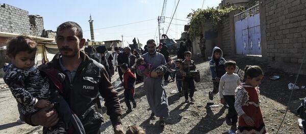 Iraqi civilians flee the village of Gogjali, a few hundred metres of Mosul's eastern edge, as clashes go on between Iraq army forces and jihadists of the Islamic State (IS) group to retake Mosul, the last Iraqi city under the control of IS, on November 2, 2016 Iraqi civilians flee the village of Gogjali, a few hundred metres of Mosul's eastern edge, as clashes go on between Iraq army forces and jihadists of the Islamic State (IS) group to retake Mosul, the last Iraqi city under the control of IS, on November 2, 2016 - Sputnik International