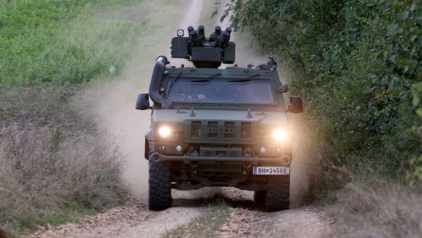 A vehicle of the Austrian army drives to patrol on the border for illegally entering migrants between Hungary and Austria in Nickelsdorf, Austria, Tuesday, Sept. 20, 2016 - Sputnik International