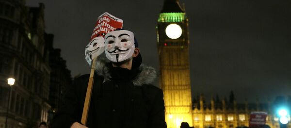 A masked demonstrator stands in Parliament Square during the Million Mask protest march in London on Thursday Nov. 5, 2015. A masked demonstrator stands in Parliament Square during the Million Mask protest march in London on Thursday Nov. 5, 2015. - Sputnik International