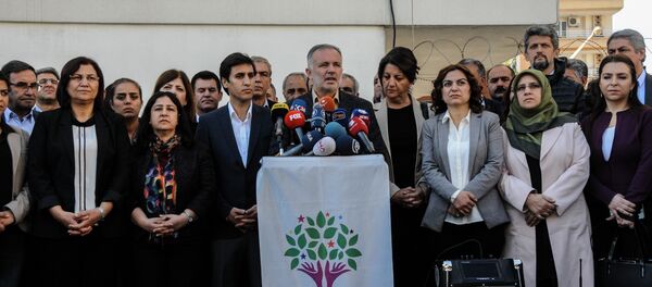 Parliament member of Pro-Kurdish Peoples' Democratic Party (HDP) and HDP spokesman Ayhan Bilgen (C) speaks on November 6, 2016 during a press conference in Diyarbakir. The pro-Kurdish People's Democratic Party (HDP) on November 6, 2016 said it was halting all its activities in the Turkish parliament after nine of its MPs, including the two co-leaders, were arrested. Parliament member of Pro-Kurdish Peoples' Democratic Party (HDP) and HDP spokesman Ayhan Bilgen (C) speaks on November 6, 2016 during a press conference in Diyarbakir. The pro-Kurdish People's Democratic Party (HDP) on November 6, 2016 said it was halting all its activities in the Turkish parliament after nine of its MPs, including the two co-leaders, were arrested. - Sputnik International