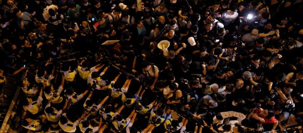 Police stop demonstrators as they protest against what they call Beijing's interference over local politics and the rule of law, a day before China's parliament is expected to announce their interpretation of the Basic Law in light of two pro-independence lawmakers' oath-taking controversy in Hong Kong, China November 6, 2016. Police stop demonstrators as they protest against what they call Beijing's interference over local politics and the rule of law, a day before China's parliament is expected to announce their interpretation of the Basic Law in light of two pro-independence lawmakers' oath-taking controversy in Hong Kong, China November 6, 2016. - Sputnik International