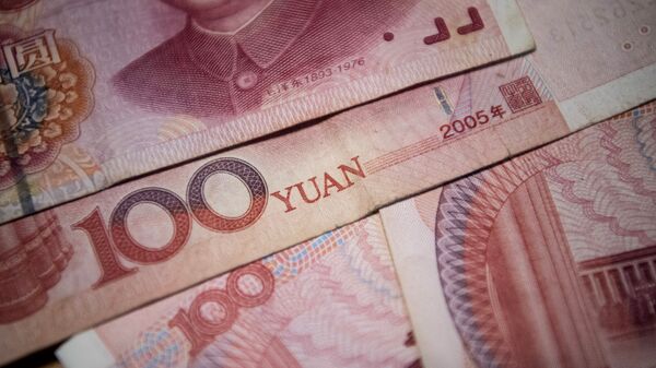 This photo illustration taken on September 29, 2016 shows Chinese 100 yuan notes in Beijing. - Sputnik International