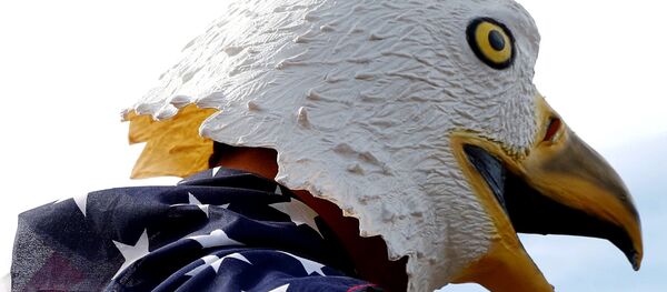A man wears an eagle mask and is draped in a US flag outside of the event site of a U.S. presidential debate between Republican nominee Donald Trump and Democratic nominee Hillary Clinton at Washington University in St. Louis, Missouri, US, October 9, 2016. A man wears an eagle mask and is draped in a US flag outside of the event site of a U.S. presidential debate between Republican nominee Donald Trump and Democratic nominee Hillary Clinton at Washington University in St. Louis, Missouri, US, October 9, 2016. - Sputnik International