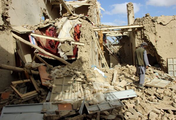 An Afghan man inspects a house destroyed during an air strike called in to protect Afghan and U.S. forces during a raid on suspected Taliban militants, in Kunduz, Afghanistan. file photo  - Sputnik International