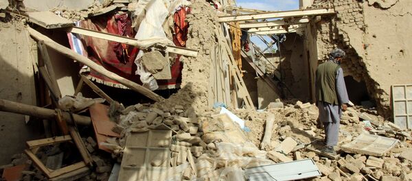 An Afghan man inspects a house destroyed during an air strike called in to protect Afghan and U.S. forces during a raid on suspected Taliban militants, in Kunduz, Afghanistan - Sputnik International