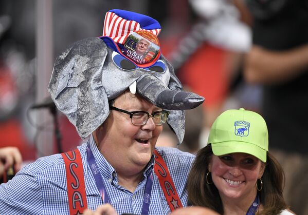 A Donald Trump supporter wears an elephant-shaped hat during the opening day of the Republican National Convention in Cleveland, Monday, July 18, 2016 - Sputnik International