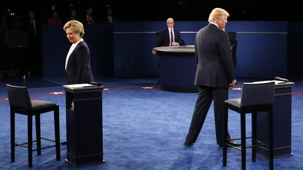 Democratic nominee Hillary Clinton (L) and Republican nominee Donald Trump arrive on stage during the second presidential debate at Washington University in St. Louis, Missouri on October 9, 2016 - Sputnik International