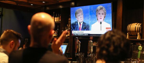 People watch the third presidential debate between presidential debate between US Democratic presidential candidate Hillary Clinton and US Republican presidential candidate Donald Trump at Murphy's Tap House in uptown Charlotte, North Carolina on October 19, 2016 People watch the third presidential debate between presidential debate between US Democratic presidential candidate Hillary Clinton and US Republican presidential candidate Donald Trump at Murphy's Tap House in uptown Charlotte, North Carolina on October 19, 2016 - Sputnik International