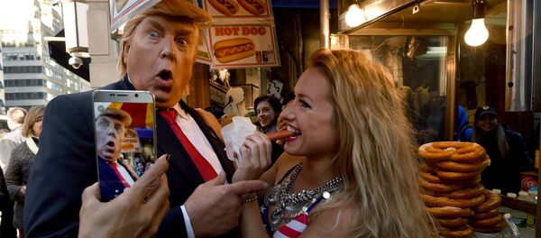 A Donald Trump impersonator with a bikini clad model stops at a hot dog vendor near Trump Tower on October 25, 2016 in New York, as part of a performance art piece by British artist Alison Jackson A Donald Trump impersonator with a bikini clad model stops at a hot dog vendor near Trump Tower on October 25, 2016 in New York, as part of a performance art piece by British artist Alison Jackson - Sputnik International