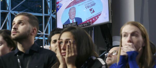 Supporters of Democratic presidential nominee Hillary Clinton watch and wait, with a Donald Trump image on a screen at rear, at her election night rally in New York, U.S., November 8, 2016 Supporters of Democratic presidential nominee Hillary Clinton watch and wait, with a Donald Trump image on a screen at rear, at her election night rally in New York, U.S., November 8, 2016 - Sputnik International