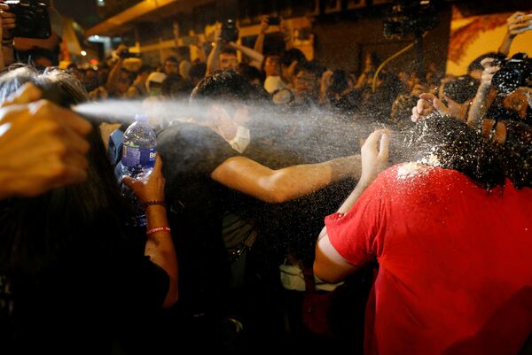 Protesters are pepper sprayed by police during a protest against what they call Beijing's interference over local politics and the rule of law, a day before China's parliament is expected to announce their interpretation of the Basic Law in light of two pro-independence lawmakers' oath-taking controversy in Hong Kong, China, November 6, 2016 Protesters are pepper sprayed by police during a protest against what they call Beijing's interference over local politics and the rule of law, a day before China's parliament is expected to announce their interpretation of the Basic Law in light of two pro-independence lawmakers' oath-taking controversy in Hong Kong, China, November 6, 2016 - Sputnik International