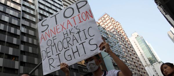 Demonstrators protest against what they call Beijing's interference over local politics and the rule of law, a day before China's parliament is expected to announce their interpretation of the Basic Law in light of two pro-independence lawmakers' oath-taking controversy in Hong Kong, China November 6, 2016 Demonstrators protest against what they call Beijing's interference over local politics and the rule of law, a day before China's parliament is expected to announce their interpretation of the Basic Law in light of two pro-independence lawmakers' oath-taking controversy in Hong Kong, China November 6, 2016 - Sputnik International