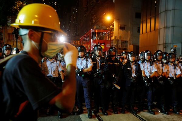 A protester stands in front of policemen outside China Liaison Office during a confrontation in Hong Kong, China November 6, 2016 A protester stands in front of policemen outside China Liaison Office during a confrontation in Hong Kong, China November 6, 2016 - Sputnik International