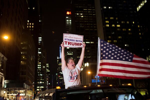 A supporter of U.S. Republican presidential candidate Donald Trump cheers near the intersection of West 54th Street and Fifth Avenue in New York, U.S. November 9, 2016 A supporter of U.S. Republican presidential candidate Donald Trump cheers near the intersection of West 54th Street and Fifth Avenue in New York, U.S. November 9, 2016 - Sputnik International