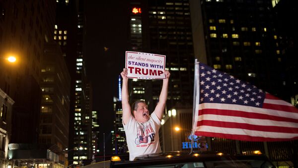 A supporter of U.S. Republican presidential candidate Donald Trump cheers near the intersection of West 54th Street and Fifth Avenue in New York, U.S. November 9, 2016 - Sputnik International