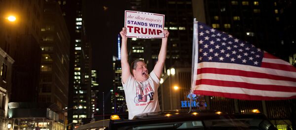 A supporter of U.S. Republican presidential candidate Donald Trump cheers near the intersection of West 54th Street and Fifth Avenue in New York, U.S. November 9, 2016 A supporter of U.S. Republican presidential candidate Donald Trump cheers near the intersection of West 54th Street and Fifth Avenue in New York, U.S. November 9, 2016 - Sputnik International