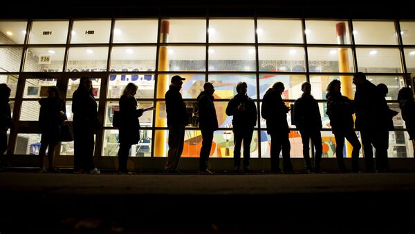 A line of voters stretches down the street as they wait for a polling site to open in New York, Tuesday, Nov. 8, 2016.  - Sputnik International
