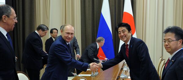 Russian President Vladimir Putin and Japanese Prime Minister Shinzo Abe shake hands at their meeting in the Bocharov Ruchei residence in Sochi, Russia, Saturday, Feb. 8, 2014. Russian President Vladimir Putin and Japanese Prime Minister Shinzo Abe shake hands at their meeting in the Bocharov Ruchei residence in Sochi, Russia, Saturday, Feb. 8, 2014. - Sputnik International
