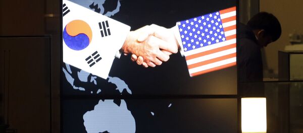 A visitor tour near the screen showing an image of a handshake by the U.S. and South Korean flags at the two countries' security alliance exhibition hall at the Korea War Memorial Museum in Seoul, South Korea, Wednesday, Jan. 14, 2015 A visitor tour near the screen showing an image of a handshake by the U.S. and South Korean flags at the two countries' security alliance exhibition hall at the Korea War Memorial Museum in Seoul, South Korea, Wednesday, Jan. 14, 2015 - Sputnik International