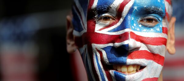 An activist with a face painted with the British Union Flag (L) and the US flag (R) poses in front of a Stop Trump battle bus in London on September 21, 2016 in a campaign run by campaign group Avaaz to mobilise US expatriots in the UK to register to vote in the US presidential election. Voters are set to go to the polls to elect the 45th president of the US on November 8, 2016. An activist with a face painted with the British Union Flag (L) and the US flag (R) poses in front of a Stop Trump battle bus in London on September 21, 2016 in a campaign run by campaign group Avaaz to mobilise US expatriots in the UK to register to vote in the US presidential election. Voters are set to go to the polls to elect the 45th president of the US on November 8, 2016. - Sputnik International