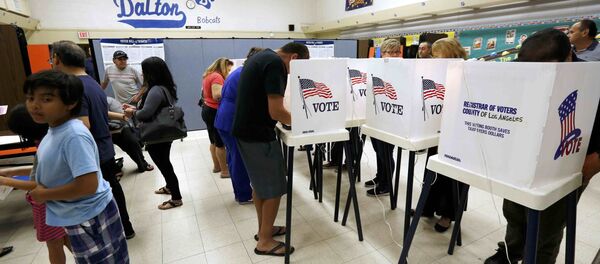 Voters cast their ballots in the Dalton Elementary School after the polling station in Azusa, California, U.S. was reopened following a shooting in the area during the U.S. presidential election November 8, 2016 - Sputnik International