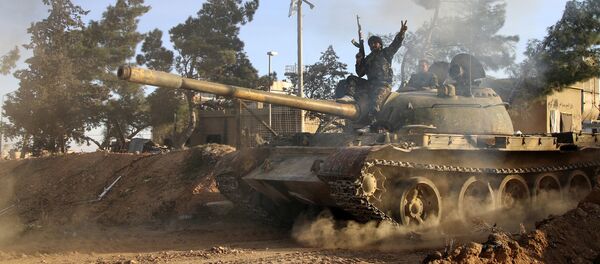 Volunteer fighter with the Syrian Government forces sits atop a tank in the province of Raqqa, Syria (File) Volunteer fighter with the Syrian Government forces sits atop a tank in the province of Raqqa, Syria (File) - Sputnik International