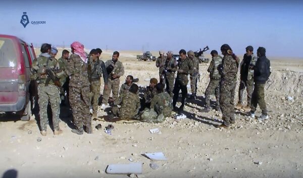 This frame grab from video provided by Qasioun a Syrian opposition media outlet, shows U.S.-backed fighters taking a rest during fighting with the Islamic State group near Ein Issa, north of Raqqa, Syria This frame grab from video provided by Qasioun a Syrian opposition media outlet, shows U.S.-backed fighters taking a rest during fighting with the Islamic State group near Ein Issa, north of Raqqa, Syria - Sputnik International