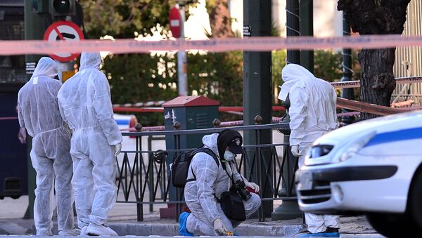 Police officers investigate at the front of the French embassy after two motorcyclists threw a hand granade injuring the guard early in central Athens on November 10, 2016 - Sputnik International