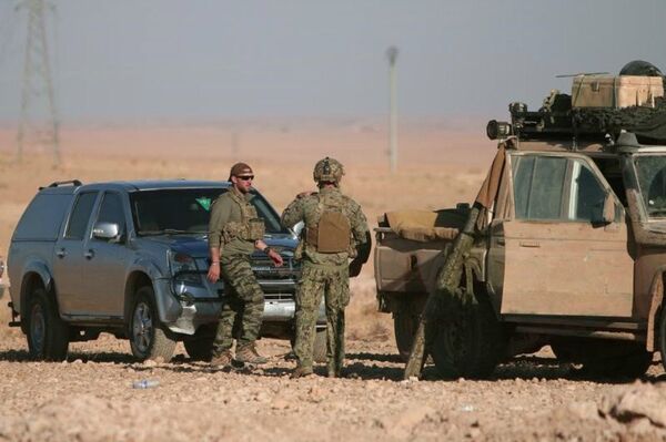 US soldiers stand near military vehicles, north of Raqqa city, Syria. File photo US soldiers stand near military vehicles, north of Raqqa city, Syria. File photo - Sputnik International