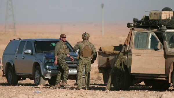 US soldiers stand near military vehicles, north of Raqqa city, Syria. File photo - Sputnik International