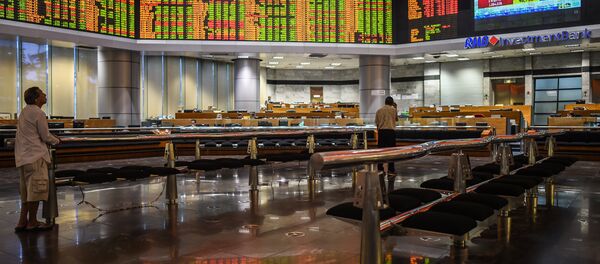 Traders monitor electronic boards showing stock movements during the final day of the US presidential election at a private stock exchange in Kuala Lumpur on November 9, 2016 Traders monitor electronic boards showing stock movements during the final day of the US presidential election at a private stock exchange in Kuala Lumpur on November 9, 2016 - Sputnik International