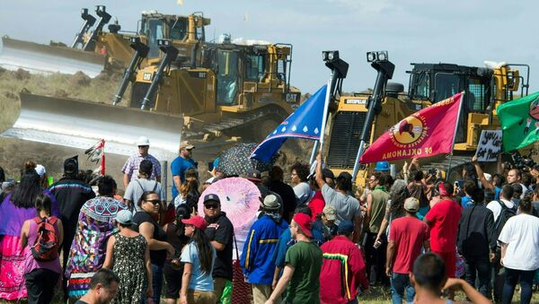 Members of the Standing Rock Sioux Tribe and their supporters opposed to the Dakota Access Pipeline (DAPL) confront bulldozers working on the new oil pipeline in an effort to make them stop, September 3, 2016, near Cannon Ball, North Dakota - Sputnik International