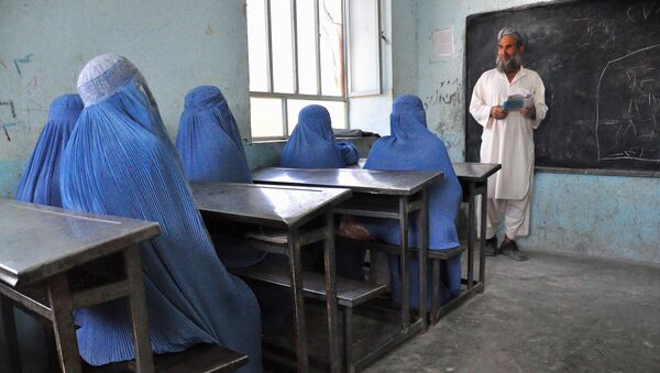 Afghan schoolgirls clad in burqas pay attention to their male teacher in the outskirts of Herat province on June 26, 2011 - Sputnik International