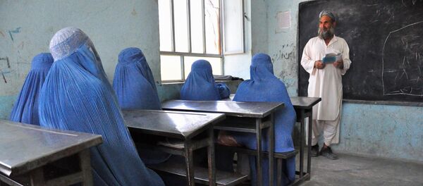 Afghan schoolgirls clad in burqas pay attention to their male teacher in the outskirts of Herat province on June 26, 2011 - Sputnik International