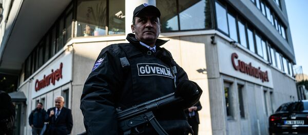 A security agent stands guard in front of Cumhuriyet newspaper headquarter (File) A security agent stands guard in front of Cumhuriyet newspaper headquarter (File) - Sputnik International