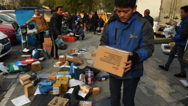 Delivery drivers sort packages for delivery at a sorting center during the 'Double Eleven' Online Shopping Festival day in Beijing on November 11, 2016 - Sputnik International