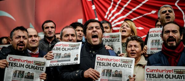 Protesters hold copies of the latest edition of the the Turkish daily newspaper Cumhuriyet as they shout slogans during a demonstration outside the newspaper's headquarters in Istanbul on November 1,2016 a day after its editor in chief was detained by police. Protesters hold copies of the latest edition of the the Turkish daily newspaper Cumhuriyet as they shout slogans during a demonstration outside the newspaper's headquarters in Istanbul on November 1,2016 a day after its editor in chief was detained by police. - Sputnik International