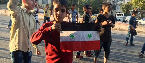 Children in the humanitarian corridor Bustan al-Qasr on the Eastern-Western Aleppo border, Syria. - Sputnik International