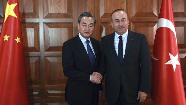 Chinese Foreign Minister Wang Yi (L) and Turkish Foreign Minister Mevlut Cavusoglu shake hands before a meeting in Ankara, on November 13, 2016. - Sputnik International