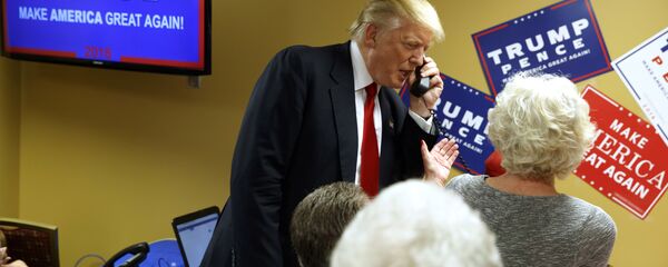 Republican presidential candidate Donald Trump talks on the phone as he visits a call center before a rally in Asheville, N.C. (File) Republican presidential candidate Donald Trump talks on the phone as he visits a call center before a rally in Asheville, N.C. (File) - Sputnik International