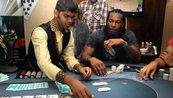 West Indies cricketer Chris Gayle plays poker on a floating casino in Panaji, Goa. (File) - Sputnik International